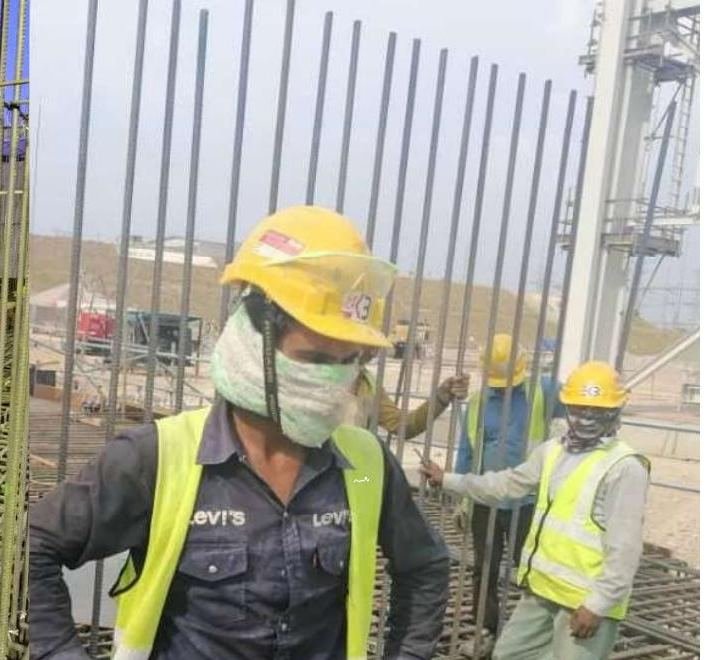 Workers tying reinforcement bars on site